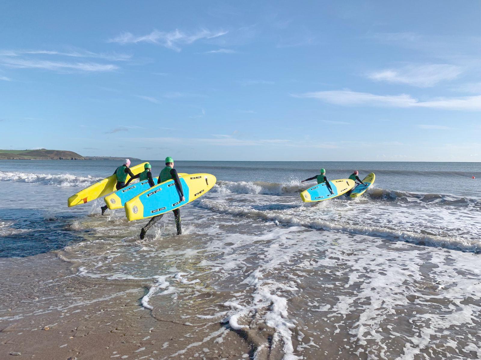 lifeguard training at beach with inflatable prone rescue boards from red rescue