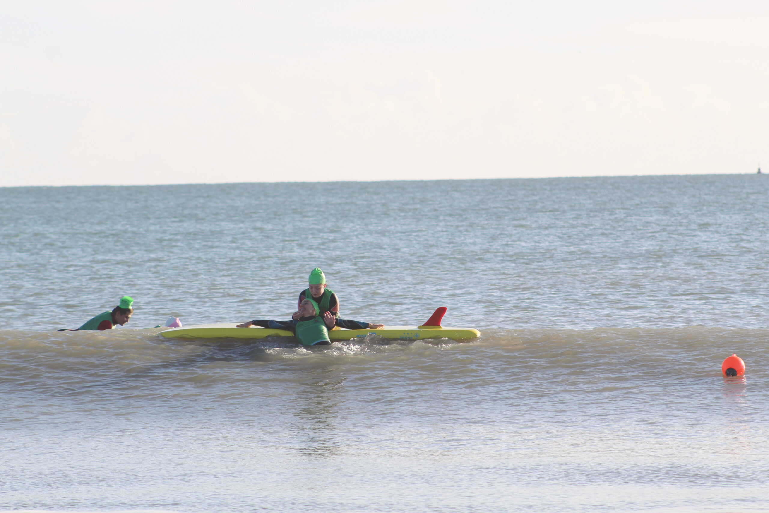 lifeguard training at beach with inflatable prone rescue boards from red rescue