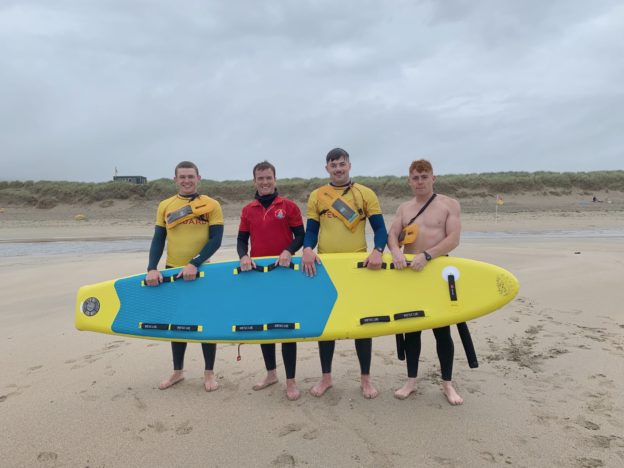 lifeguard training at beach with inflatable prone rescue boards from red rescue