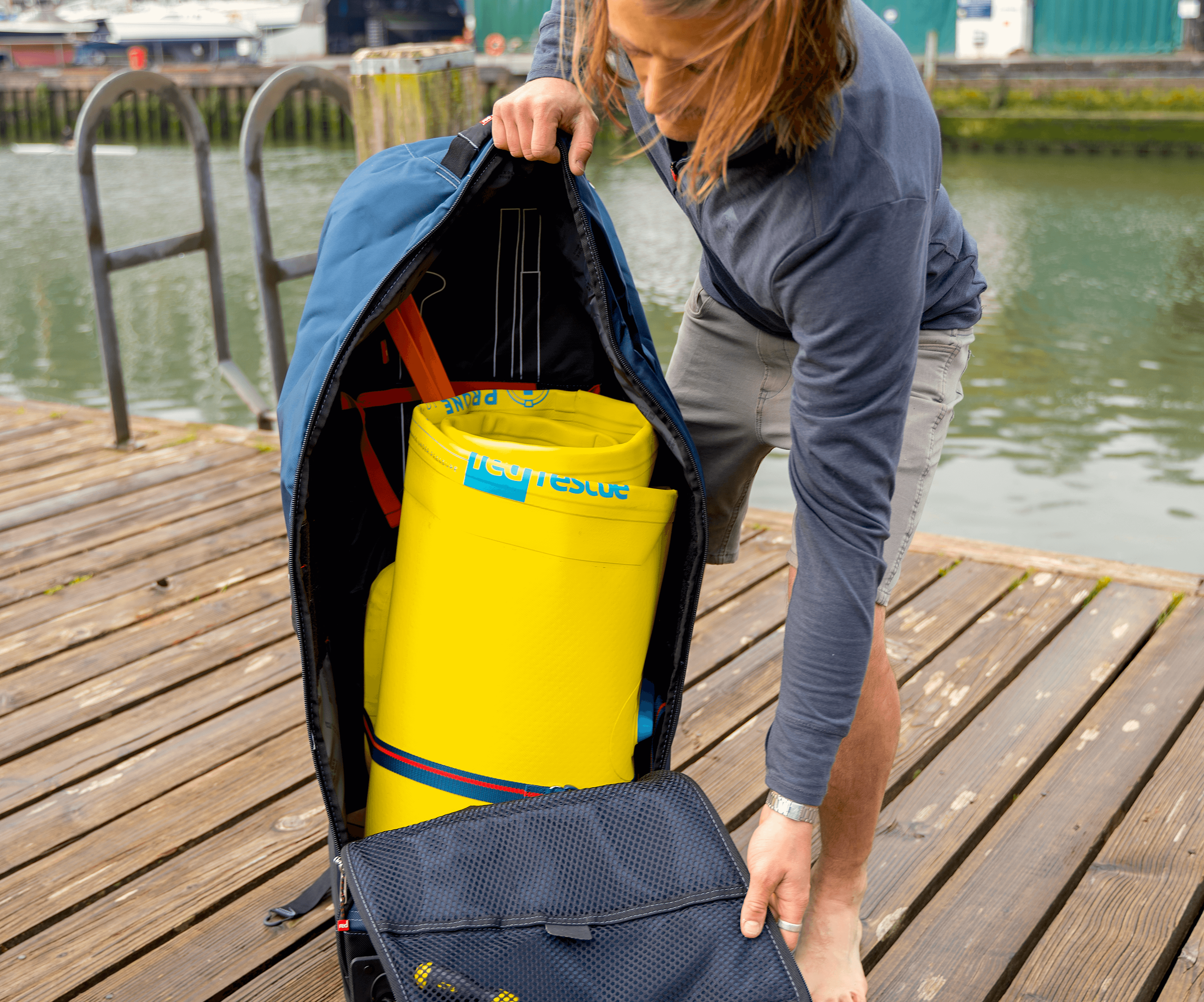 lifeguard with transportable inflatable prone rescue board in bag for water safety event